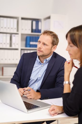 Serious young businessman sitting listening